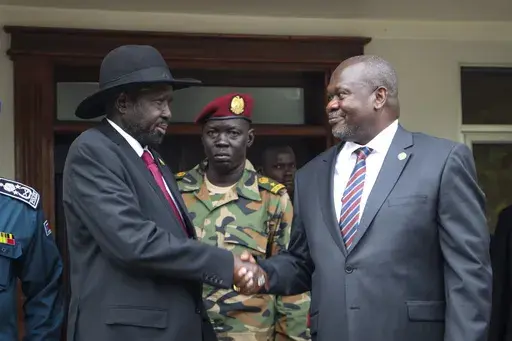 South Sudan's president Salva Kiir, left, and vice-president Riek Machar, right, shake hands after meetings in Juba, South Sudan, on Oct. 20, 2019, to discuss outstanding issues to the peace deal. (AP Photo/Sam Mednick, File)