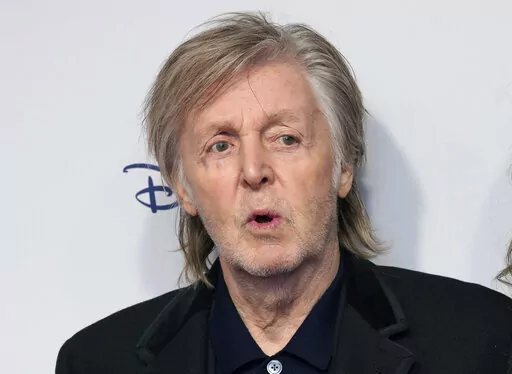 Paul McCartney and Nancy Shevell pose for photographers upon arrival for the premiere of the film 'If These Walls Could Sing' in London, Monday, Dec. 12, 2022. A trove of previously unseen photos taken by Paul McCartney as The Beatles shot to global stardom will go on display in London this year. The National Portrait Gallery announced Wednesday, Jan. 25, 2023 that the exhibition, titled “Eyes of the Storm,” will help mark the gallery's reopening in June after a three-year refurbishment.(Pho