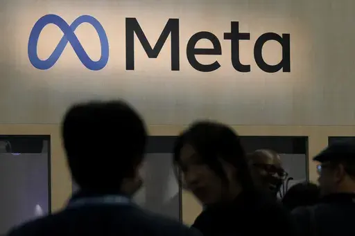 Attendees visit the Meta booth at the Game Developers Conference in San Francisco on March 22, 2023. (AP Photo/Jeff Chiu, File)