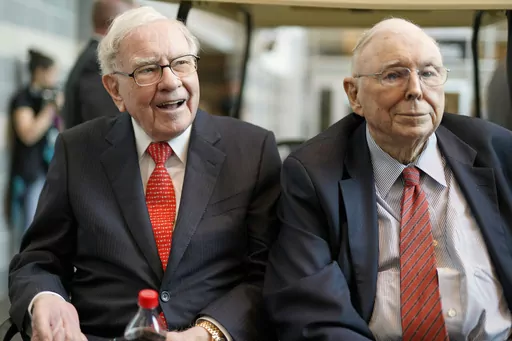 FILE- In this May 3, 2019 file photo, Berkshire Hathaway Chairman and CEO Warren Buffett, left, and Vice Chairman Charlie Munger, briefly chat with reporters before Berkshire Hathaway's annual shareholders meeting. Buffett credited his longtime partner — the late Charlie Munger — with being the architect of the Berkshire Hathaway conglomerate he’s received the credit for leading and warned shareholders in his annual letter not to listen to Wall Street pundits or financial advisors who urge