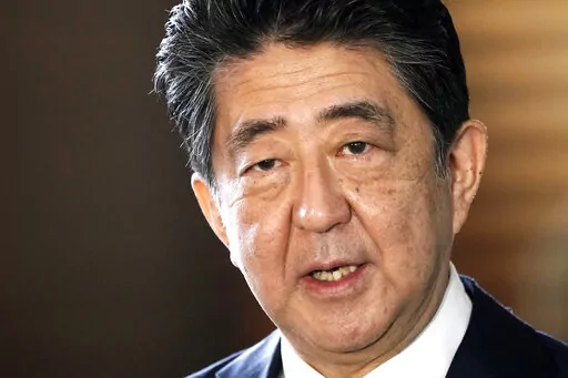 Japan's outgoing Prime Minister Shinzo Abe speaks to the media as he arrives at the prime minister's office for a cabinet meeting in Tokyo on Sept. 16, 2020. Japanese former Prime Minister Shinzo Abe was assassinated Friday, July 8, 2022, by a gunman who opened fire on him as he delivered a campaign speech on a street in western Japan.(AP Photo/Eugene Hoshiko, File)