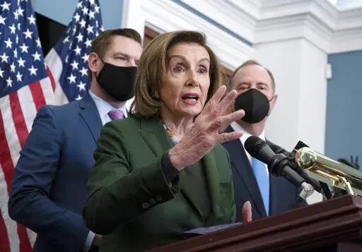 Speaker of the House Nancy Pelosi, D-Calif., flanked by Rep. Eric Swalwell, D-Calif., left, and House Intelligence Committee Chairman Adam Schiff, D-Calif.,holds a news conference at the Capitol in Washington, Wednesday, Feb. 23, 2022.  Pelosi says the Russian attack on Ukraine is “an attack on democracy.” Pelosi vowed Wednesday the U.S. is united with world leaders in swiftly imposing sanctions on Putin’s aggression and ensuring financial support for the independent nation.  (AP Photo/J. 