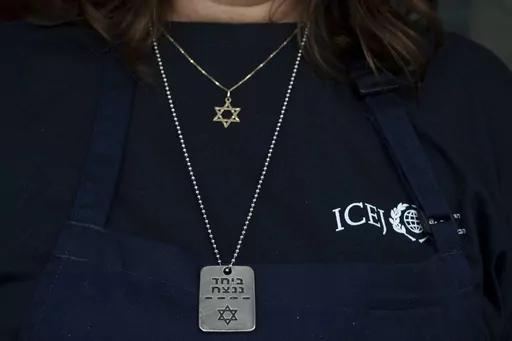 Elisabeth Odegaard poses for a portrait with necklaces as she prepares food for Israeli soldiers on a brief respite from combat operations in the Gaza Strip, in Tel Aviv, Wednesday, March 6, 2024. Her visit to Israel is part of a wave of religious "voluntourism" to Israel, organized trips that include some kind of volunteering aspect connected to the ongoing war in Gaza. Israel's Tourism Ministry estimates around a third to half of the approximately 3,000 visitors expected to arrive each day in 