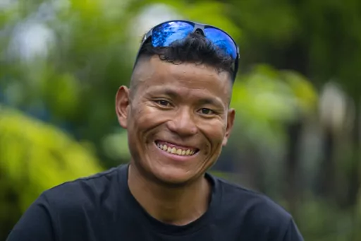 Nepal's sherpa guide Tenjen Sherpa, 35, who with Norwegian climber Kristin Harila climbed the world's 14 tallest mountains in record time, poses during an interview with the Associated Press in Kathmandu, Nepal, Wednesday, Aug. 9, 2023. Sherpa and Harila shattered the record for the fastest climb of the 14 mountains more than 8,000 meters (about 26,000 feet) high when they topped Mount K2 in Pakistan late last month. The previous record was 189 days, and the pair did it in 92 days. (AP Photo/Nir
