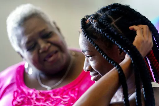 Cassandra Gentry and her granddaughter Jada pose for a photograph in their apartment in Washington, Friday, Oct. 7, 2022. (AP Photo/Andrew Harnik)