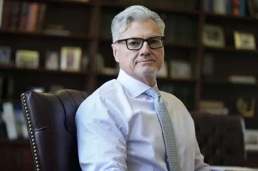 Judge Juan M. Merchan poses in his chambers in New York, Thursday, March 14, 2024. Former President Donald Trump is demanding a new judge just days before his hush-money criminal trial is set to begin, rehashing longstanding grievances with Merchan, the current judge, in a long-shot, eleventh-hour bid to disrupt and delay the case. (AP Photo/Seth Wenig)