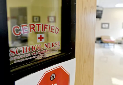This photo taken Aug. 15, 2016, shows the front of the Bellefonte Area School District certified school nurses office. Schools are confronting soaring absence rates. Some are calling for parents to send their children to class even if they are not feeling 100% well. During the pandemic, schools urged parents and children to stay home at any sign of illness. Now that the COVID-19 emergency has ended, guidance on when to keep children home varies widely. The American Academy of Pediatrics recommen