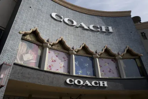 A chain of the Coach brand, owned by parent company Tapestry, is seen, May 3, 2019, at the Citadel Outlets in Commerce, Calif. (AP Photo/Richard Vogel, File)