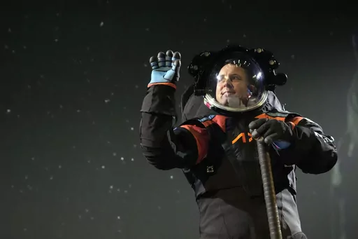 Axiom Space chief engineer Jim Stein demonstrates a prototype spacesuit, Wednesday, March 15, 2023, in Houston. NASA selected Axiom Space to design the spacesuits that its moonwalking astronauts will wear when they step onto the lunar surface later this decade. (AP Photo/David J. Phillip)