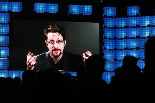 Former U.S. National Security Agency contractor Edward Snowden addresses attendees through video link at the Web Summit technology conference in Lisbon on Nov. 4, 2019. Snowden, who fled prosecution after he revealed highly classified U.S. surveillance programs, has received a Russian passport and taken the citizenship oath, his lawyer was quoted by Russian news agencies as saying Friday Dec. 2, 2022. (AP Photo/Armando Franca, File)