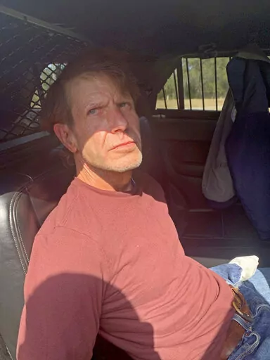 Michael Floyd Wilson, an inmate who escaped from the Central Mississippi Correctional Facility, is shown in custody in this photo provided to media outlets by the Harrison County Sheriff's Office, taken after he was captured Tuesday, Feb. 15, 2022. Wilson, who was convicted of multiple crimes, including the killing of two men escaped on Saturday, Feb. 12, 2022. (Harrison County Sheriff's Office via the AP)