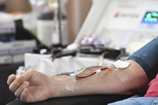 A person donates blood to the American Red Cross during a blood drive in Pottsville, Pa. on Thursday, Jan. 13, 2022. Gay and bisexual men in monogamous relationships will be able to donate blood in the U.S. for the first time in decades, under a new federal policy finalized Thursday, May 11, 2023, by health regulators.(Lindsey Shuey/Republican-Herald via AP, File)