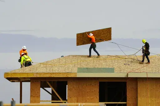 Work is done on the roof of a building under construction in Sacramento, Calif., Thursday, March 3, 2022. The California Employment Development Department said Friday, Aug. 19, 2022, that the state's unemployment rate was 3.9% in July. That's the lowest since 1976 when the state began using its current method of measuring job growth. (AP Photo/Rich Pedroncelli,File)