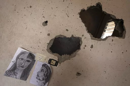 Drawings by Duniana al-Amour are seen in her damaged bedroom which was hit by Israeli strike, east of Khan Yunis, in the southern Gaza Strip, Monday, Aug. 10, 2022. Al-Amour, a 22-year-old Palestinian woman who had retreated into her artistic pursuits during Gaza's past wars was among the first people killed by Israeli strikes in the latest round of violence. Shrapnel tore through her bedroom during Israel’s surprise opening salvo last Friday, hours before militants fired any rockets. (AP Phot