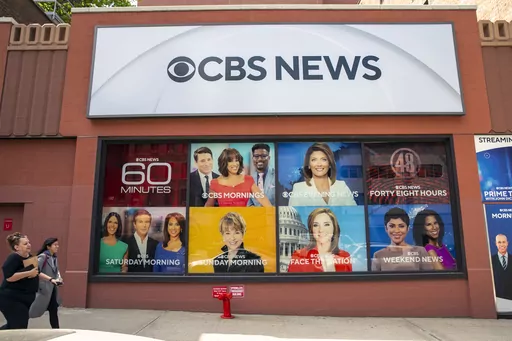 People walk by the CBS Broadcast Center on 57th Street in New York on April 20, 2023. CBS News has asked all of its local stations to become proficient in “solutions journalism,” a story-telling method that has taken off in the past decade to counter people who think reporters are obsessed with bad news. (AP Photo/Ted Shaffrey, File)