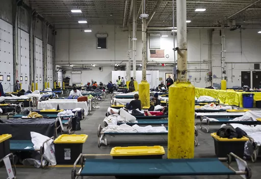 People rest on cots, set up as an emergency cold weather shelter in the former Solid Waste Services administration building, in Anchorage, Alaska, Wednesday, Nov. 8, 2023. Anchorage scrambled Tuesday, Nov. 14, to come up with more temporary housing for the homeless after back-to-back snowstorms that dumped more than 3 feet of snow on the city and a forecast of sub-zero temperatures just days away. Several people have already died outside this fall. (Emily Mesner/Anchorage Daily News via AP)