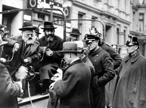 A busload of arrested Jewish men are questioned by government officials before being taken away in Berlin on April 11, 1933, shortly after Adolf Hitler's takeover of power in Germany. The notion of being Jewish is complicated and includes a combination of religion, race, nationality, ethnicity, culture and history, says Greg Schneider, executive vice president the Conference on Jewish Material Claims Against Germany, also referred to as the Claims Conference. (AP Photo/File)