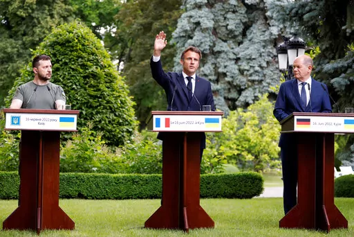 From left, Ukraine President Volodymyr Zelenskyy, France's President Emmanuel Macron and German Chancellor Olaf Scholz attend a press conference in Kyiv, Thursday, June 16, 2022. The leaders of four European Union nations visited Ukraine on Thursday, vowing to back Kyiv's bid to become an official candidate to join the bloc in a high-profile show of support for the country fending off a Russian invasion. (Ludovic Marin, Pool via AP)