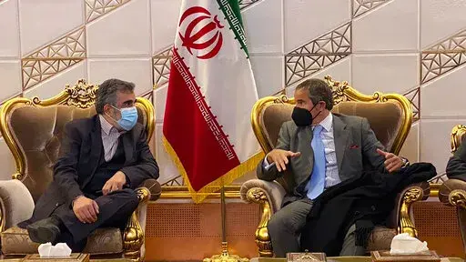 Director General of International Atomic Energy Agency, IAEA, Rafael Mariano Grossi, right, speaks with deputy head of the Atomic Energy Organization of Iran Behrouz Kamalvandi at Imam Khomeini Airport, in Tehran, Iran, Nov. 22, 2021. Iran announced Sunday, July 10, 2022, that it has begun enriching uranium up to 20% using sophisticated centrifuges at its underground Fordo nuclear plant, state TV reported, an escalation that comes amid a standoff with the West over its tattered atomic deal. Kama