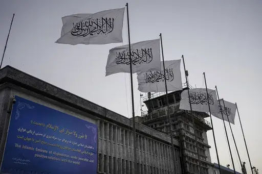 Taliban flags fly at the airport in Kabul, Afghanistan, Sept. 9, 2021. Two years on from the Taliban takeover of Afghanistan, the United States has begun easing rules that could allow commercial airlines to fly over the country in routes that cuts time and burned fuel for East-West travel. But those flights shortening routes for India and Southeast Asia raise questions never answered during the Taliban's previous rule from the 1990s to the months after the Sept. 11, 2001, attacks. (AP Photo/Bern