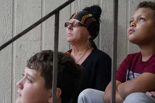 Kim Carlson, from left, and her two grandsons Thomas Heidt, 12, and Treveyon Carlson, 9, pose for a photograph outside her apartment at the Delta Pines complex, Friday, Nov. 4, 2022, in Antioch, Calif. Despite a landmark renter protection law approved by California legislators in 2019, tenants across the country’s most populous state are taking to ballot boxes and city councils to demand even more safeguards. They want to crack down on tenant harassment, shoddy living conditions and unresponsi