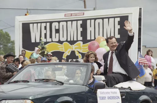 Former hostage Terry Anderson waves to the crowd as he rides in a parade in Lorain, Ohio, June 22, 1992. Anderson, the globe-trotting Associated Press correspondent who became one of America’s longest-held hostages after he was snatched from a street in war-torn Lebanon in 1985 and held for nearly seven years, died Sunday, April 21, 2024. He was 76. (AP Photo/Mark Duncan, File)
