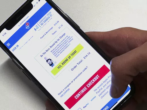 An option to donate to St. Jude Children's Research Hospital appears on the Domino's app in a photo taken in New York on Wednesday, May 15, 2024. Domino's is the latest and largest example of philanthropic allies new and old finding success through "checkout charity." (AP Photo/Peter Morgan)