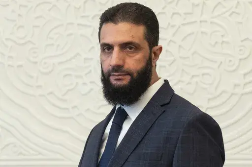 Syria's de facto leader Ahmad al-Sharaa, formerly known as Abu Mohammed al-Golani, walks in the presidential palace ahead of his meeting with Walid Ellafi, Libyan minister of state for communication and political affairs, in Damascus, Dec. 28, 2024. (AP Photo/Mosa'ab Elshamy, File)