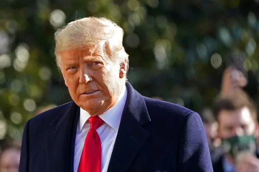 President Donald Trump walks to board Marine One on the South Lawn of the White House on Jan. 12, 2021, in Washington. Questioned for a lawsuit, former President Donald Trump hurled insults and threatened to sue the columnist who accused him of raping her in a department store in the 1990s, according to excerpts of his testimony unsealed by a court on Friday, Jan. 13, 2023. (AP Photo/Gerald Herbert, File )