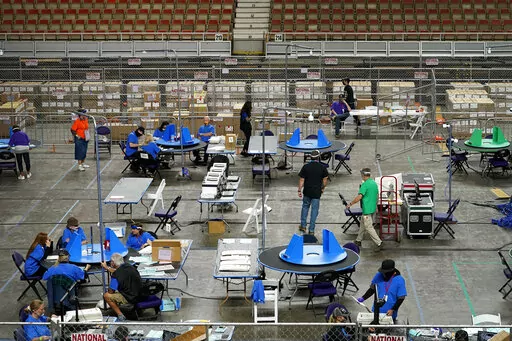 Maricopa County ballots cast in the 2020 general election are examined and recounted by contractors working for Florida-based company, Cyber Ninjas, in Phoenix on May 6, 2021. A judge has blocked a rural Arizona county's plan to hand-count all the ballots in the Nov. 8, 2022, election. The full hand-count was ordered by Republican officials in Cochise County who have made unfounded claims that vote-counting machines are untrustworthy. The ruling on Monday, Nov. 7, from Pima County Superior Court