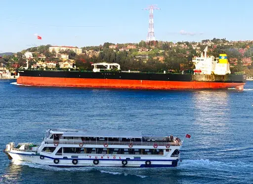 The Greek-flagged oil tanker Prudent Warrior, background, is seen as it sails past Istanbul, Turkey, April 19, 2019. Iran's paramilitary Revolutionary Guard seized two Greek oil tankers on Friday, May 27, 2022, in helicopter-launched raids in the Persian Gulf, according to officials. The actions were an apparent retaliation for Athens assisting the U.S. in seizing Iranian crude oil in the Mediterranean Sea over violating Washington's crushing sanctions on the Islamic Republic. (Dursun Çam via A