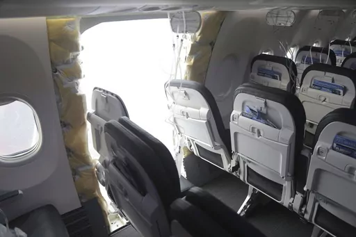 This image taken Sunday, Jan. 7, 2024, and released by the National Transportation Safety Board, shows a section of Alaska Airlines Flight 1282 that is missing panel on a Boeing 737-9 MAX in Portland, Ore. Federal officials are investigating Boeing's oversight of production of a panel that blew off a jetliner in midflight last week. (NTSB via AP)
