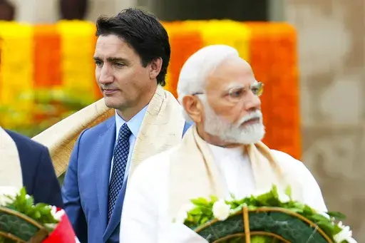Canada's Prime Minister Justin Trudeau, left, walks past India's Prime Minister Narendra Modi as they take part in a wreath-laying ceremony at Raj Ghat, Mahatma Gandhi's cremation site, during the G20 Summit in New Delhi, Sept. 10, 2023. (Sean Kilpatrick/The Canadian Press via AP, File)