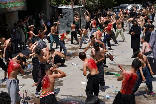 Shiite Muslim men beat themselves with knives attached to chains during a procession to mark Ashoura, three days ahead of Ashoura, in a mosque in Kabul, Afghanistan, Friday, Aug. 5, 2022. Ashoura falls on the 10th day of Muharram, the first month of the Islamic calendar, when Shiites mark the death of Hussein, the grandson of the Prophet Muhammad, at the Battle of Karbala in present-day Iraq in the 7th century. (AP Photo/Ebrahim Noroozi)
