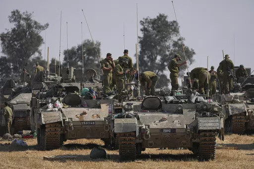Israeli soldiers are seen at a staging ground near the border with the Gaza Strip, in southern Israel, Tuesday, April 30, 2024. (AP Photo/Tsafrir Abayov)