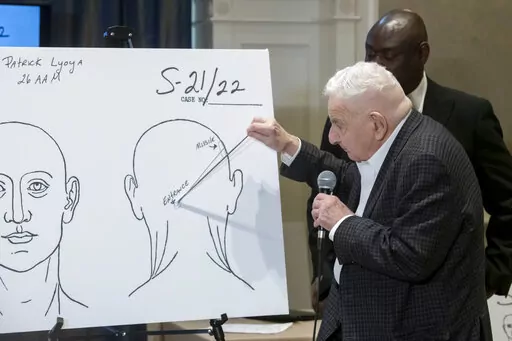 Forensic pathologist Dr. Werner Spitz uses a chart to demonstrate the direction of the bullet that killed Patrick Lyoya during a press conference at the Westin hotel in Detroit, Tuesday, April 19, 2022. Lyoya died of a gunshot wound to the back of head after a confrontation with a Grand Rapids, Mich., police officer during an April 4 traffic stop according to Dr. Spitz. (David Guralnick/Detroit News via AP)