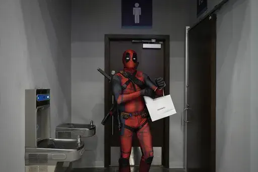 A cosplayer dressed as Deadpool attends a Comic-Con convention in Panama City, Sunday, Sept. 1, 2024. (AP Photo/Matias Delacroix)