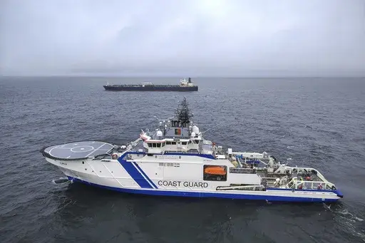This photo provided by Rajavartiosto (Finnish Border Guard) on Thursday, Dec. 26, 2024, shows the oil tanker Eagle S, background, and the Finnish Border Guard ship Turva at sea outside Porkkalanniemi, Finland. The Eagle S was sailing at the same time in the area where the Finland-Estonia electrical link was disrupted on Wednesday. (Rajavartiosto via AP)