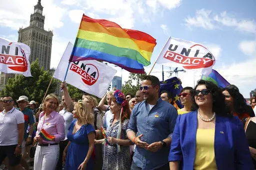 Warsaw's mayor Rafal Trzaskowski, second right, and European Commissioner for Equality, Hanna Dalli, right,  take part in the 'Warsaw and Kyiv Pride' marching for freedom in Warsaw, Poland, Saturday, June 25, 2022. Due to Russia's full-scale war against Ukraine the 10th anniversary of the equality march in Kyiv can't take place in the usual format in the Ukrainian capital. The event joined Warsaw's yearly equality parade, the largest gay pride event in central Europe, using it as a platform to k
