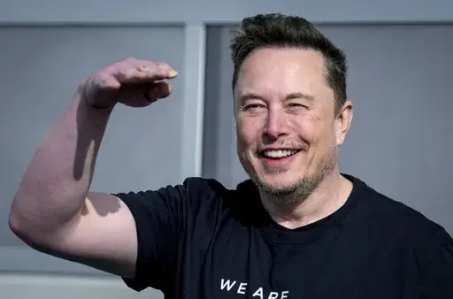 Tesla CEO Elon Musk waves as he leaves the Tesla Gigafactory for electric cars in Gruenheide near Berlin, Germany on March 13, 2024. Tesla shareholders are charting the future of the electric vehicle company Thursday, June 13, 2024, as they wrap up voting whether or not to restore Musk's massive pay package that was thrown out by a Delaware judge. (AP Photo/Ebrahim Noroozi, File)