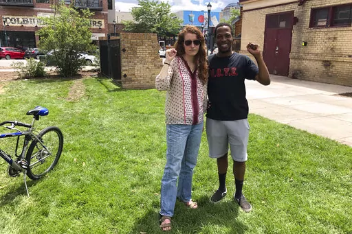 Maryah Lauer and Chauncy Johnson pose for a photo in Colorado Springs, Colo., shortly after interrupting a rally featuring Sen. Michael Bennet, D-Colo., on June 29, 2022. Lauer and Johnson pressed Bennet to be more aggressive responding to the Supreme Court's ruling last month revoking the constitutional right for women to obtain an abortion. (AP Photo/Nick Riccardi)