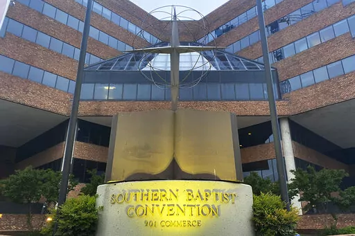 A cross and Bible sculpture stand outside the Southern Baptist Convention headquarters in Nashville, Tenn., on May 24, 2022. The Executive Committee of the Southern Baptist Convention said Friday, Aug. 12, 2022, that several of the denomination's major entities are under investigation by the U.S. Department of Justice. (AP Photo/Holly Meyer, File)
