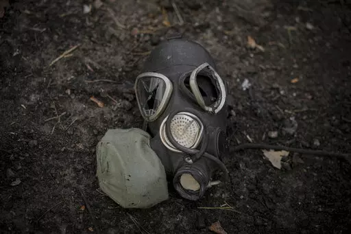 A damaged gas mask lies on the pavement at a Russian position which was overran by Ukrainian forces, outside Kyiv, Ukraine, March 31, 2022. Russia’s assault on Ukraine and its veiled threats of using nuclear arms have policymakers questioning how the West should respond to a Russian battlefield explosion of a nuclear bomb. The default U.S. policy answer, say some architects of the post-Cold War nuclear order, is with discipline and restraint. (AP Photo/Vadim Ghirda, File)