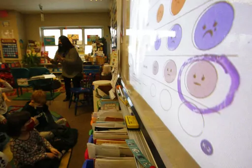Second-grade teacher Melissa Shugg teaches a lesson at Paw Paw Elementary School about thoughts, feelings and actions on Dec. 2, 2021, in Paw Paw, Michigan. Shugg is one of many teachers at the school who've been trained to teach a social-emotional curriculum created at the University of Michigan called TRAILS. Research suggests TRAILS lessons for at-risk kids can reduce depression and improve coping skills — something district officials say has been particularly important during the pandemic.