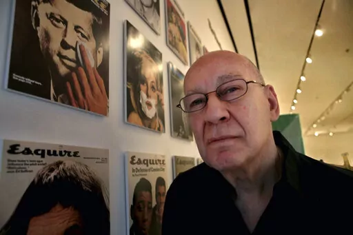 Artist George Lois poses next to his artwork at the New York Museum of Modern Art (MoMA) in New York, April 22, 2008. Lois, the hard-selling, charismatic advertising man and designer who fashioned some of the most daring magazine images of the 1960s and popularized such catchphrases and brand names as “I Want My MTV” and “Lean Cuisine,” has died at age 91. Lois' son, photographer Luke Lois, said he died “peacefully” Friday, Nov. 18, 2022, at his home in Manhattan. (AP Photo/Bebeto Ma
