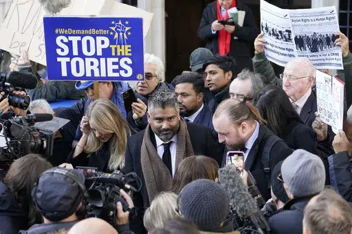 Lawyer Tofique Hossain addresses the media outside the Supreme Court in London, Wednesday, Nov. 15, 2023. Britain's Supreme Court has ruled that the government's contentious plan to send some migrants on a one-way trip to Rwanda is illegal. Five justices on the country's top court said Wednesday that asylum-seekers would be "at real risk of ill-treatment" because they could be sent back to their home countries once they were in Rwanda.The ruling is a major blow to a key government policy that ha