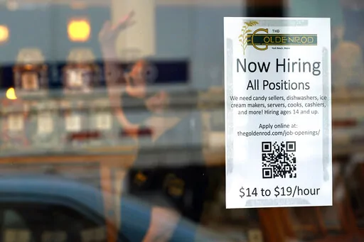 A sign advertises for help at The Goldenrod, a popular restaurant and candy shop, Wednesday, June 1, 2022, in York Beach, Maine. It’s a hot job market right now, and that extends to the youngest workers. Given the strife and isolation of the past couple of years, it’s teens who may have the most to gain by going to work this summer.  (AP Photo/Robert F. Bukaty)