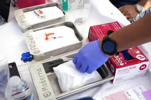 Syringes with vaccines are prepared at the L.A. Care and Blue Shield of California Promise Health Plans' Community Resource Center where they were offering members and the public free flu and COVID-19 vaccines Friday, Oct. 28, 2022, in Lynwood, Calif. The U.S. is poised to make COVID-19 vaccinations more like a yearly flu shot, a major shift in strategy despite a long list of questions about how to best protect against a still rapidly mutating virus.The Food and Drug Administration asked its sci