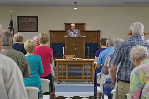 The Rev. Bill Farmer, center, speaks to members of the congregation during service at the Grace Methodist Church Sunday, May 14, 2023, in Homosassa Springs, Fla. The new congregation was created by former United Methodists after their previous congregation voted to stay in that denomination. Grace Church affiliated with the more conservative Global Methodist Church. A quarter of U.S. congregations in the United Methodist Church have received permission to leave the denomination during a five-yea