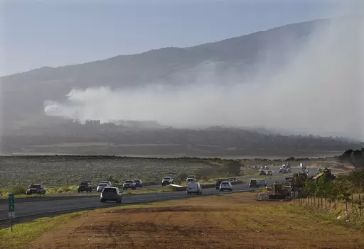 Smoke blows across the slope of Haleakala volcano on Maui, Hawaii, as a fire burns in Maui's upcountry region on Tuesday, Aug. 8. 2023. Several Hawaii communities were forced to evacuate from wildfires that destroyed at least two homes as of Tuesday as a dry season mixed with strong wind gusts made for dangerous fire conditions. (Matthew Thayer/The Maui News via AP)